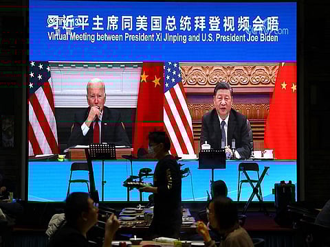 Screen shows Chinese President Xi Jinping attending a virtual meeting with US President Joe Biden via video link, at a restaurant in Beijing.