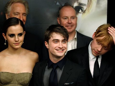FILE PHOTO: Cast members Rupert Grint (R), Daniel Radcliffe and Emma Watson (L) arrive for the premiere of the film "Harry Potter and the Deathly Hallows: Part 2" in New York July 11, 2011.  REUTERS/Lucas Jackson/File Photo