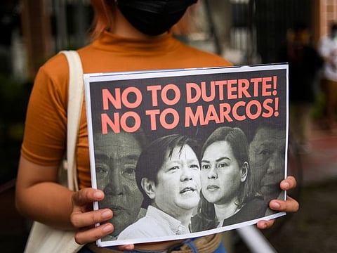 A demonstrator holds a poster during a protest following the presidential bid announcement of Ferdinand “Bongbong” Marcos Jr., son of late dictator Ferdinand Marcos, at the Commission of Human Rights, in Quezon City, Metro Manila, on October 6, 2021.  