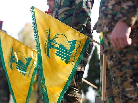 Hezbollah members hold flags marking Resistance and Liberation Day, in Kfar Kila near the border with Israel, southern Lebanon, on May 25, 2021. Lebanon is facing a diplomatic crisis as Gulf states become increasingly dismayed by Hezbollah’s expanding influence over Lebanese politics. 
