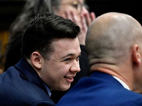Kyle Rittenhouse speaks with his attorneys during his trial at the Kenosha County Courthouse in Kenosha, U.S.