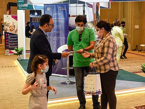 Visitors learn about immigration options at GNICE in Dubai on Saturday 
