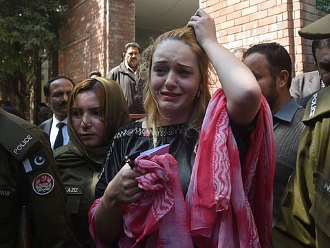 In this file photo taken on March 20, 2019 Czech model Tereza Hluskova weeps after the court decision to sentence her to eight years and eight months in prison for allegedly trafficking heroin, in Lahore. Hluskova, sentenced to over eight years in prison for drug trafficking in Pakistan in 2019 was released on November 20, 2021 after her acquittal this month, the Czech foreign minister said.