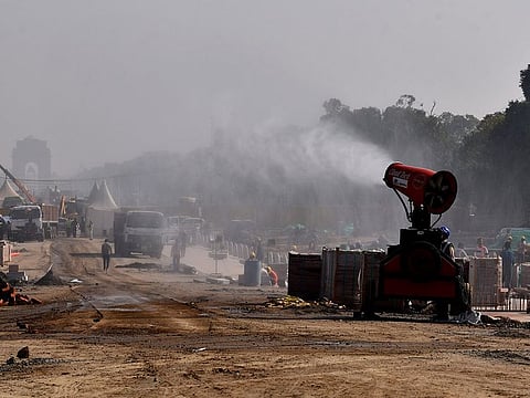 An anti-smog gun sprays water to curb air pollution, at Vijay Chowk, in New Delhi on November 22, 2021.