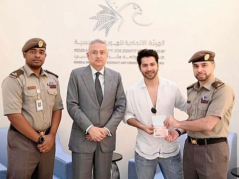 Bollywood actor Varun Dhawan (second from right) getting his UAE golden visa