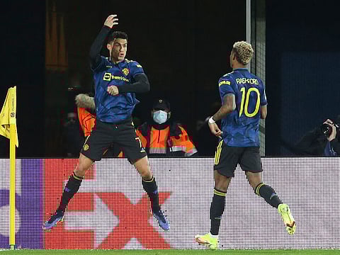 Manchester United's Cristiano Ronaldo, left, celebrates after scoring the opening goal.