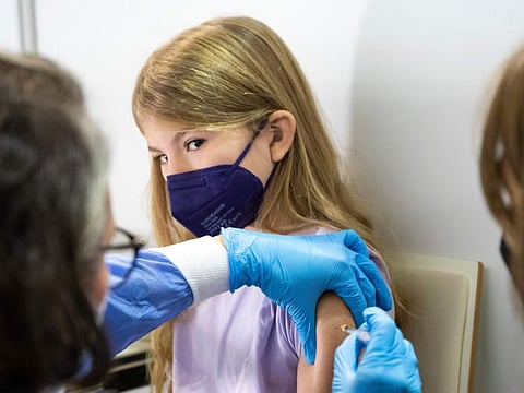 A young girl receives the Pfizer vaccine against COVID-19 in Vienna, in a file picture.