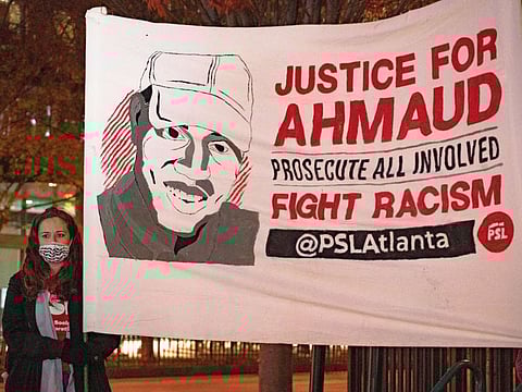 People participate in a vigil following the guilty verdict for the defendants in the trial of the killers of Ahmaud Arbery on November 24, 2021 in Atlanta, Georgia. Greg McMichael, his son Travis McMichael, and a neighbor, William "Roddie" Bryan were found guilty in the February 2020 fatal shooting of 25-year-old Ahmaud Arbery in Brunswick, Georgia.