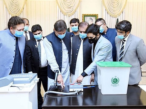  PM Imran Khan inspects EVMs developed by the Minister of Science and Technology in this August 5, 2021 picture.