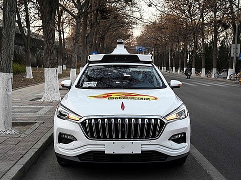 An Apollo Go autonomous taxi on a street in Yizhuang, a town of Daxing District, in the southeast suburbs of Beijing.