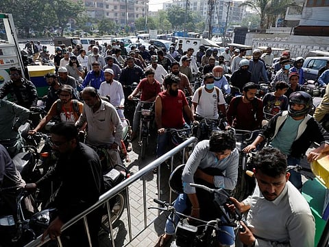 People on motorcycles wait for their turn to get petrol at a petrol station, after Pakistan Petroleum Dealers Association (PPDA) announced a countrywide strike, in Karachi, Pakistan November 25, 2021. 