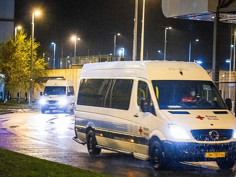  Red Cross vans transporting passengers of flights from South Africa who have tested positive drive to a hotel where they will be quarantined on November 27, 2021, at Amsterdam’s Schiphol airport. Dutch health authorities said that 61 passengers from two flights from South Africa tested positive and the results were being examined for the new Omicron variant. The people who tested positive were now being quarantined in a hotel near Amsterdam’s Schiphol Airport, where the 600 people on board the two planes from Johannesburg spent hours waiting on November 26.