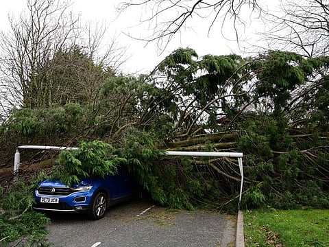 A car, crushed by a fallen tree and lamppost, in Birkenhead, north west England on November 27, 2021.