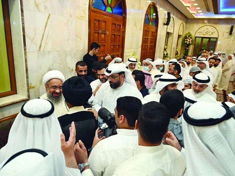 Crowds gather around Hussain Al Matuq after his return to Kuwait.