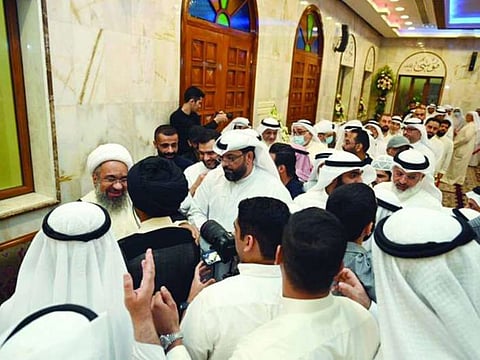 Crowds gather around Hussain Al Matuq after his return to Kuwait.