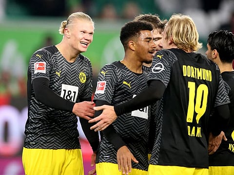 Borussia Dortmund's Erling Braut Haaland (left) celebrates scoring their third goal with his teammates.