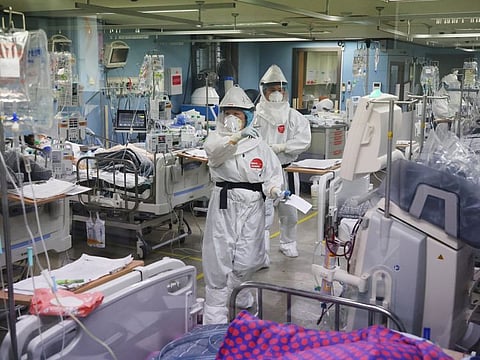 Medical workers check a COVID-19 patient at the intensive care unit (ICU) of Bagae Hospital in Pyeongtaek, South Korea, on November 29, 2021.  