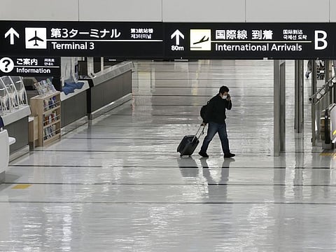 An international arrivals lobby is deserted at Narita International Airport in Narita, east of Tokyo, Japan, Monday, Nov. 29, 2021. Japan’s NHK national television said the country’s transport ministry on Wednesday, Dec. 1,  requested international airlines to stop taking new reservations for all flights arriving in Japan until the end of December. AP