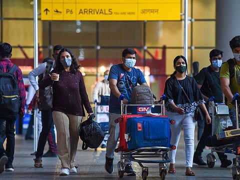 Arriving passengers leave a terminal at the Chhatrapati Shivaji Maharaj International Airport in Mumbai on December 1, 2021.  AFP