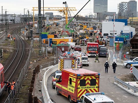 Police and firefighters secure the scene after an old aircraft bomb exploded during construction work at a bridge the busy main train station, injuring three people in Munich, Germany, December 1, 2021.
