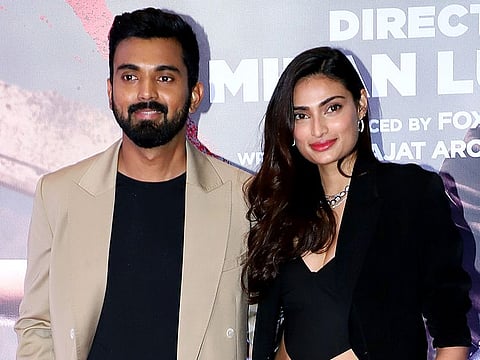 Bollywood actress Athiya Shetty with cricketer KL Rahul pose for a photo at the special screening of the movie "Tadap", in Mumbai on Wednesday.