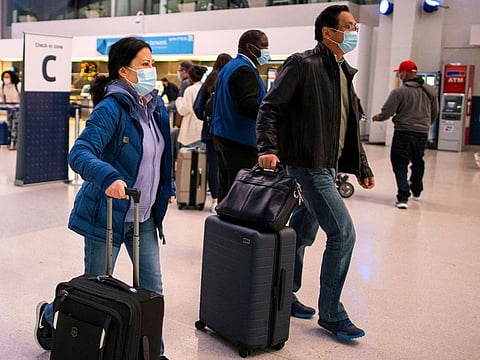 Passengers walk through the terminal at Newark Liberty International Airport in Newark, New Jersey, US, on November 24, 2021. 