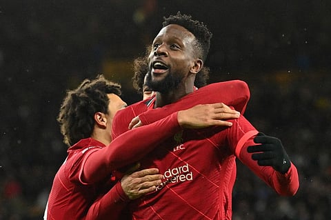 Liverpool striker Divock Origi celebrates after he scores his team's winner in the English Premier League football match against Wolves at the Molineux stadium in Wolverhampton, central England.