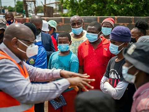 Residents listen to Gauteng Province Premier David Makhura in Lawley,  South Africa, for the launch of the Vooma vaccination programme against COVID-19 on December 3, 2021. 