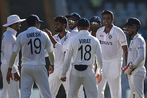India's Ravichandran Ashwin (second right) celebrates with his teammates after taking the wicket of New Zealand's Ross Taylor (not pictured) during the third day of the second Test cricket match between India and New Zealand at the Wankhede Stadium in Mumbai.