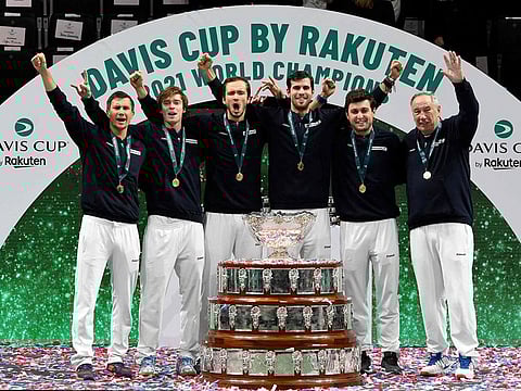 (From L) Russian team members Evgeny Donskoy, Andrey Rublev, Daniil Medvedev, Karen Khachanov, Aslan Karatsev and captain Shamil Tarpischev pose for pictures with the trophy after winning the Davis Cup tennis tournament in Madrid on December 5, 2021.