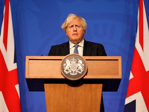 Britain's Prime Minister Boris Johnson speaks at a press conference in London's Downing Street, Wednesday Dec. 8, 2021, after ministers met to consider imposing new restrictions in response to rising cases and the spread of the Omicron variant.