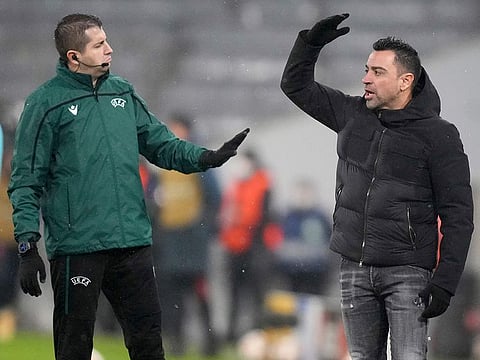 Barcelona’s head coach Xavi, right, reacts during the Champions League match agains Bayern Munich in Munich, Germany, Wednesday, Dec. 8, 2021. 