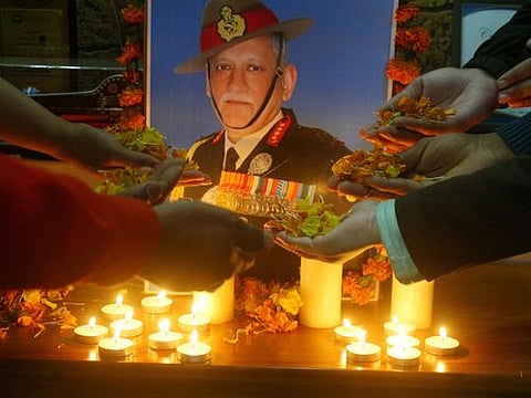 Army officers carry the coffins containing the mortal remains of India's defence chief General Bipin Rawat and 12 other victims who lost their lives in a helicopter crash a day earlier, during a tribute ceremony at Palam Air Force station in New Delhi on December 9, 2021. AFP