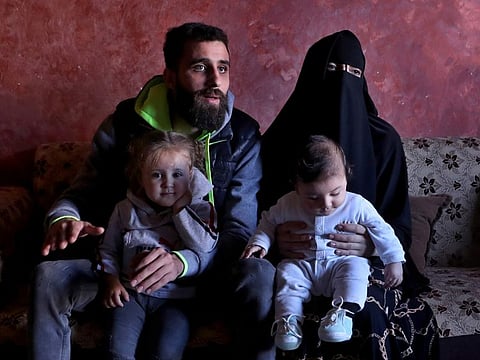 Ziad Khaled Hilweh, 23, who tried to migrate to Europe with his family, speaks during an interview as he sits with his wife Alaa Khodr, 22, his daughter Jana 2 year-old and his son Karim 3 months, at his parents house in the northern city of Tripoli, Lebanon, Monday, Dec. 6, 2021. Lebanese are setting off from the port city of Tripoli to attempt the perilous journey by boat to Cyprus and beyond in the hopes of reaching Europe. 
