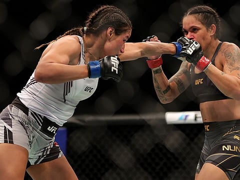 Julianna Pena (left) lands a left on Amanda Davies during their UFC 269 Championship fight in Las Vegas on Saturday.