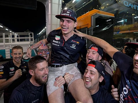 Red Bull driver Max Verstappen celebrates with his team after he became the world champion by winning the Formula One Abu Dhabi Grand Prix on Sunday, Dec. 12, 2021.