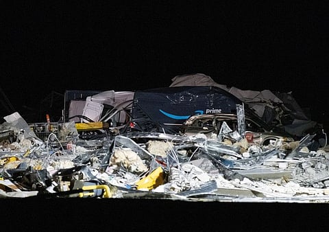 A damaged Amazon truck is seen at the site of a roof that collapsed at the Amazon distribution centre, after clean up stopped in Edwardsville, Illinois.