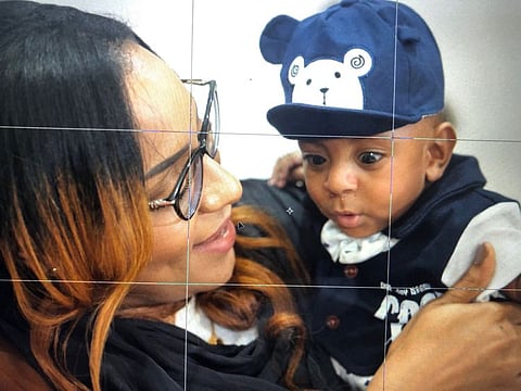 Baby Mohamed, now a bonny baby, with his mum Elbashir. 