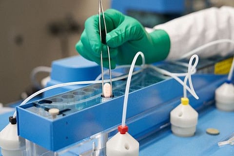 This file handout photo provided to AFP on November 16, 2021 courtesy of Pfizer shows the making of its experimental Covid-19 antiviral pills, Paxlovid, in his laboratory in Freiburg, Germany.  