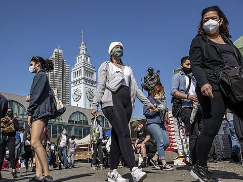 Visitors walk around San Francisco’s Embarcadero at the farmer's market. 