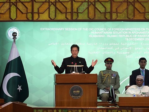 Pakistan Prime Minister Imran Khan, center, speaks during the 17th extraordinary session of Organisation of Islamic Cooperation Council of Foreign Ministers, in Islamabad on December 19, 2021. The economic collapse of Afghanistan, already teetering dangerously on the edge, would have a "horrendous" impact on the region and the world, successive speakers warned Sunday at the start of a one-day summit of foreign ministers. (AP Photo/Rahmat Gul)