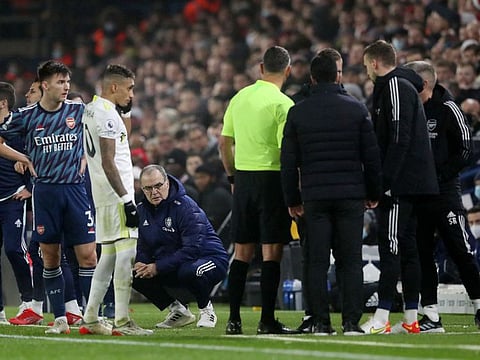 Leeds United manager Marcelo Bielsa looks on as referee Andre Marriner talks to Arsenal manager Mikel Arteta, Rob Holding and coaching staff after an incident involving a fan at Elland Road on Saturday.
