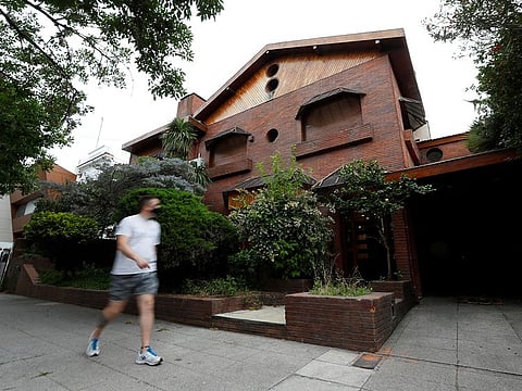 A person walks past a house owned by late Argentine soccer legend Diego Maradona, in Buenos Aires. 