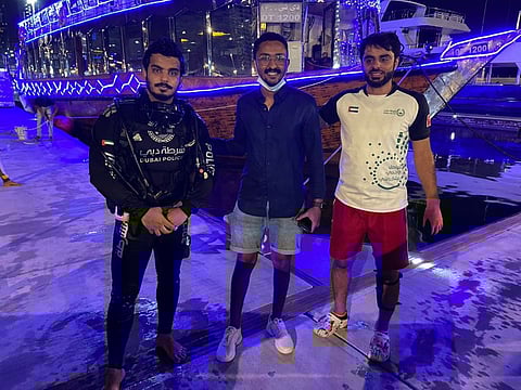 Dubai Police team who recovered the phone from the sea and reunited it with its owner (centre)