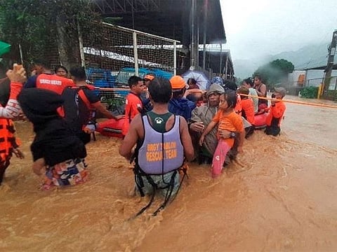 Philippine Coast Guard personnel assist in the evacuation of residents due to flooding caused by Typhoon Rai in Cagayan De Oro City, Philippines