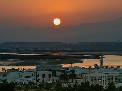 The setting sun over the city of Sur in Oman. 