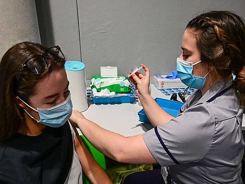 A member of the public receives her COVID-19 vaccine inside the newly-set up vaccination centre at Alder Hey Children's Hospital in Liverpool on December 20, 2021, as the booster rollout accelerates in England.