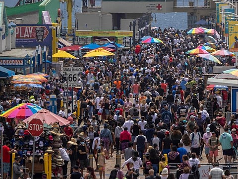 People fill the Santa Monica Pier in California during Memorial Day as COVID-19 shutdowns are relaxed in May 31 photo.