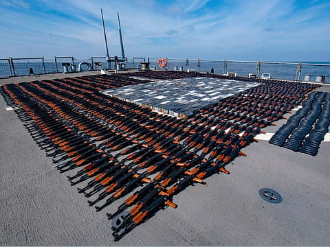 Illicit weapons seized from a stateless fishing vessel in the North Arabian Sea are arranged for inventory aboard guided-missile destroyer USS O'Kane's (DDG 77) flight deck.  