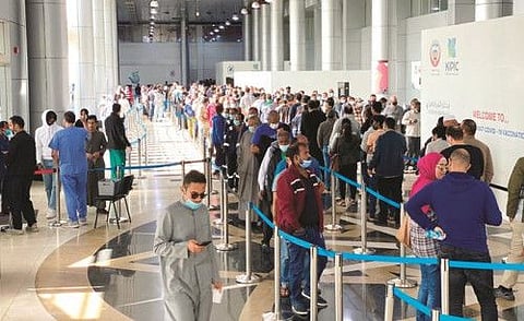 Residents line up to get vaccinated in Kuwait city.
